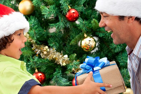 A boy gives his father a gift from the Holiday Gift Shop