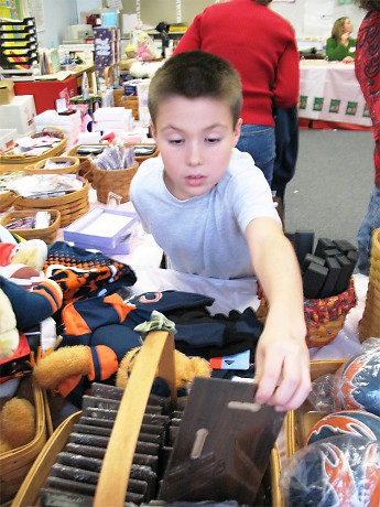 Boy picking out gifts for his family at the Holiday Gift Shop